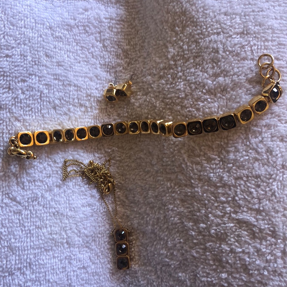Gold-colored necklace, earrings, and bracelet with swarovski crystals